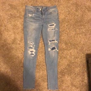 AEO light wash jeans w small rips